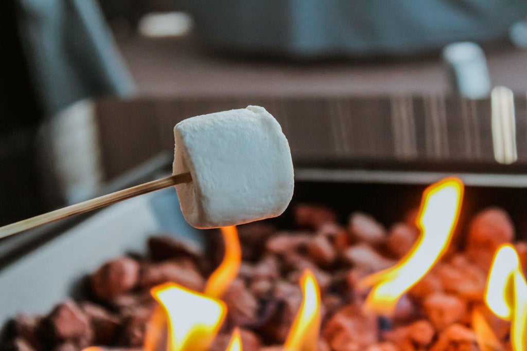 Closeup of a Roasting Marshmallow on a gas fire pit.